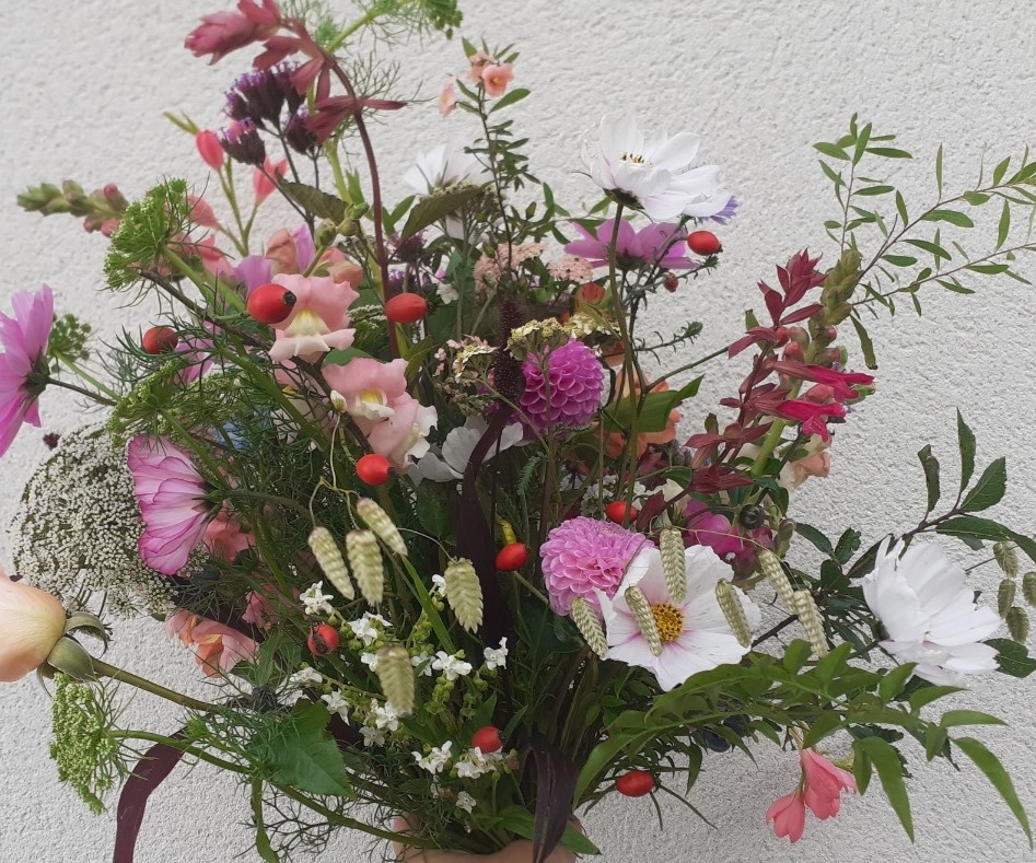 Colourful garden-style hand-tied bouquet with pink dahlias, snapdragons, and white cosmos